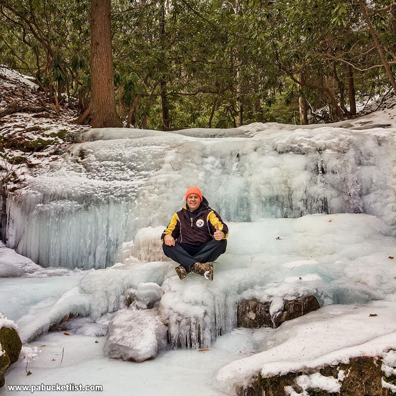 The author sitting on frozen Kyler Fork Falls.