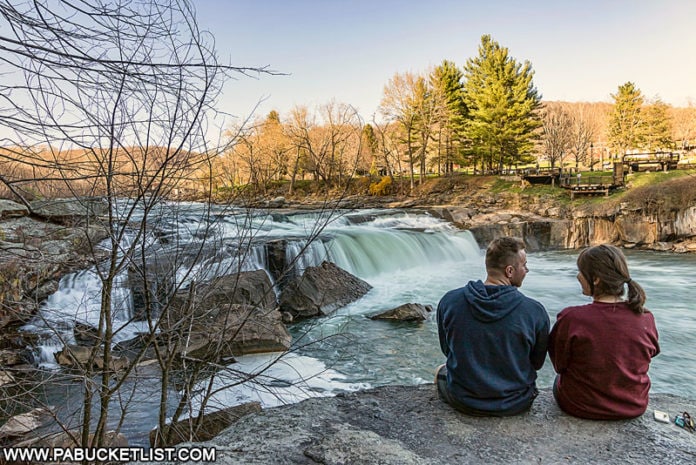 A young couple enjoying the magnificent view at the Ohiopyle Falls overlook along the Ferncliff Trail.