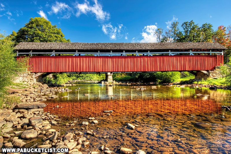 A reflection of Kings Covered Bridge in the still waters of Laurel Hill Creek.