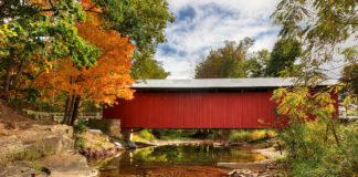 New Baltimore Covered Bridge surrounded by fall foliage.
