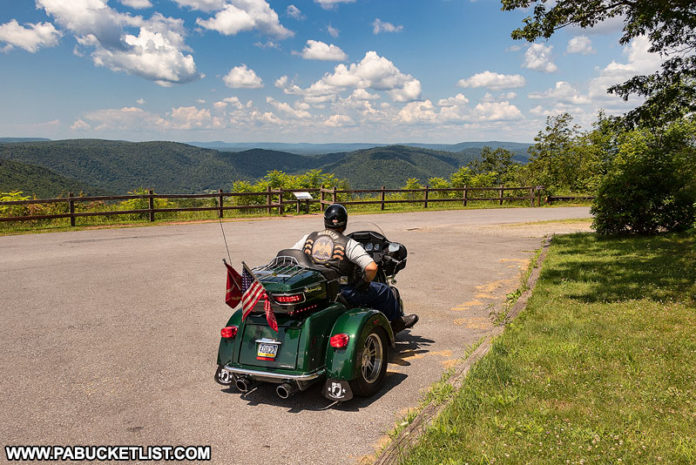A biker enjoying the scenic view from High Knob Overlook.