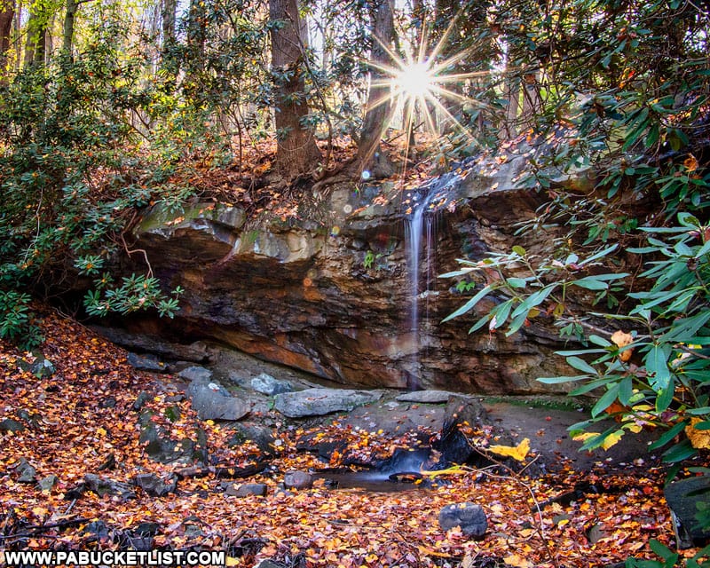 The sunsetting behind Hippie Shower Falls along the Great Allegheny Passage in Fayette County.