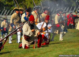 Historical reenactors staging an attack on Fort Ligonier.