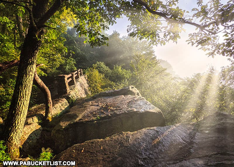 Morning sun rays piercing the fog at Baughman Rock Overlook at Ohiopyle State Park.
