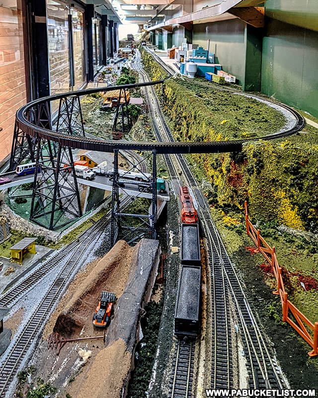 The model train display runs the length of the train car that houses the display.