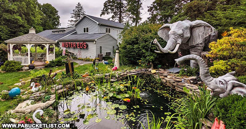 An elephant-themed water garden in front of Mister Ed's Elephant Museum and Candy Emporium.