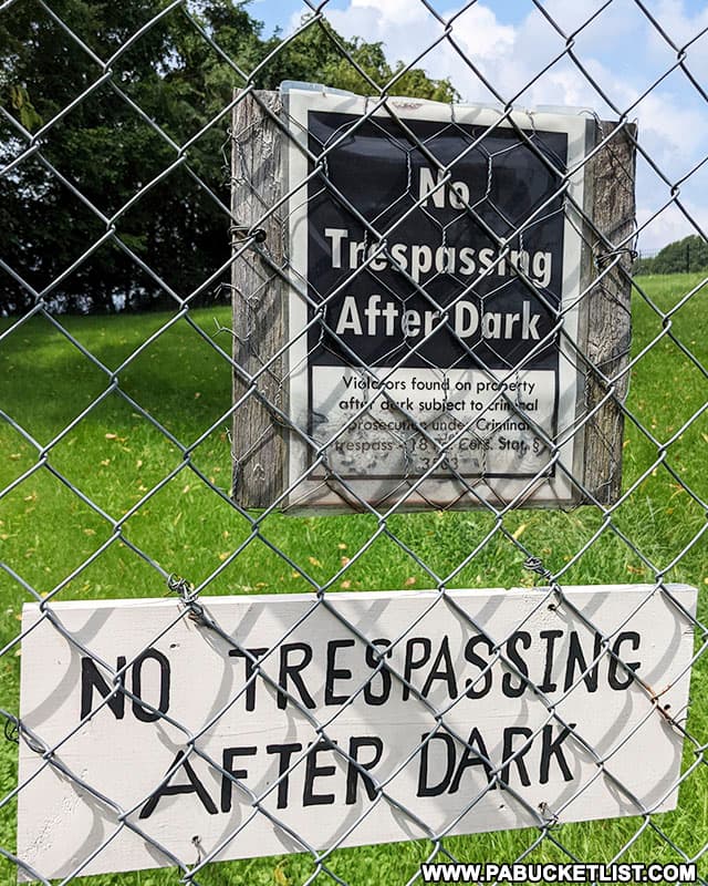 "No Trespassing After Dark" signs on the gates of the Quaker cemetery and chapel outside Perryopolis in Fayette County.