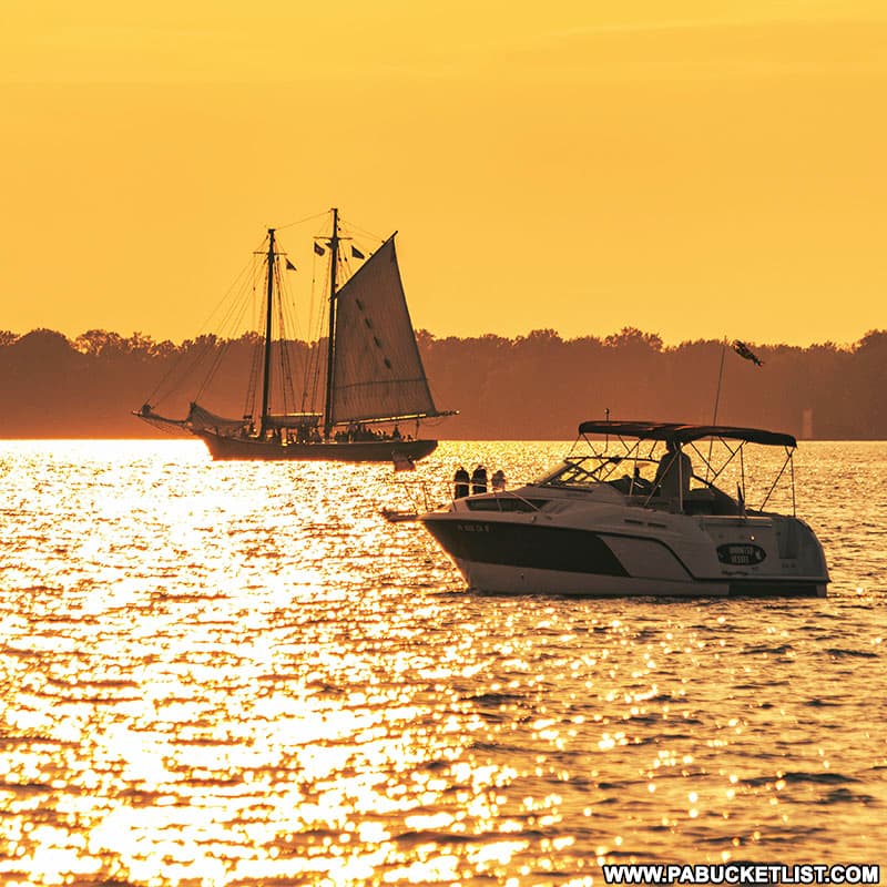 Boats position themselves to view the sunset near Presque Isle State Park in Erie.