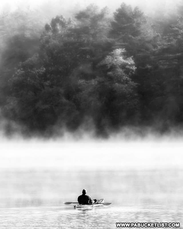 Kayaker in the mist on Lake Shawnee at Shawnee State Park in Bedford County, PA.