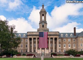 Old Glory hanging from the front of Old Main at Penn State.