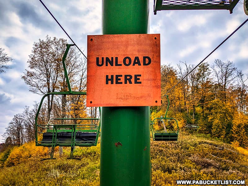 "Unload Here" sign on one of the ski lifts at the abandoned ski resort at Denton Hill State Park.