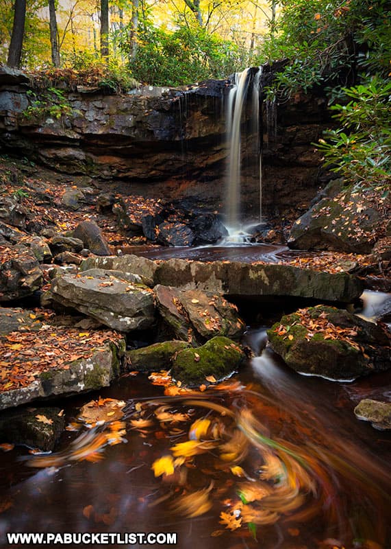 The upper tier of Cole Run Falls in the Forbes State Forest, surrounded by fall foliage.