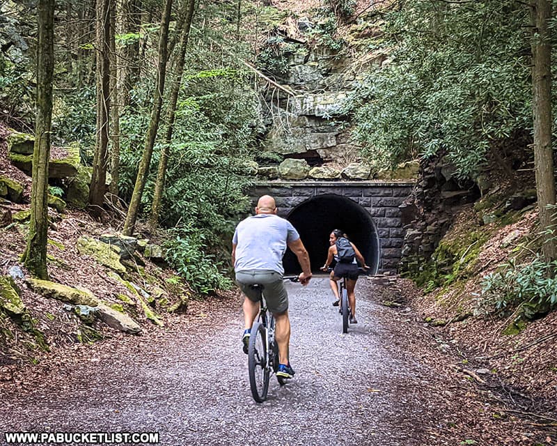 Cyclists entering Poe Paddy Tunnel through the northwestern portal.
