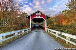 Front view of the Glessner Covered Bridge in Somerset County, surrounded by fall foliage.