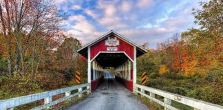 Front view of the Glessner Covered Bridge in Somerset County, surrounded by fall foliage.