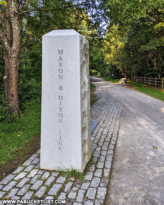 Granite obelisk marking the Mason-Dixon Line along the Great Allegheny Passage.