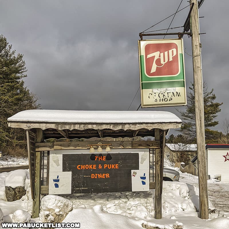 Roadside sign in front of the Choke and Puke Diner in Loganton, Pennsylvania.