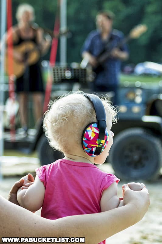 Young fan listening to a band on the beach at Whipple Dam State Park.