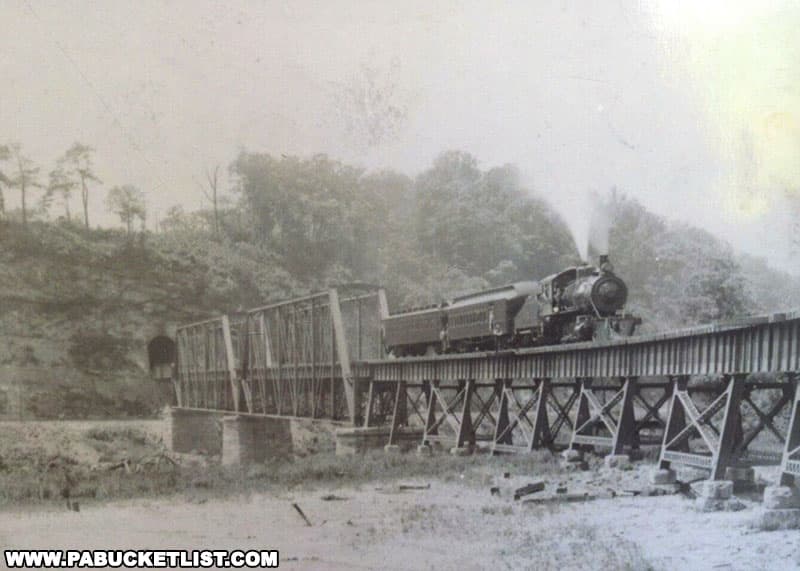 A train emerging from the Layton Tunnel and crossing the Layton Bridge in Fayette County Pennsylvania.