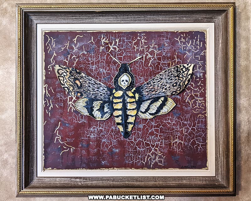 A print of a Death's-head moth, a tribute to the role these moths play in the Silence of the Lambs movie.