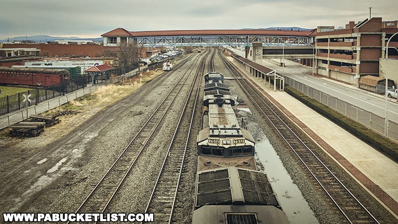 A westbound Norfolk Southern train passing beneath the Altoona Railroaders Museum railroad overlook bridge.