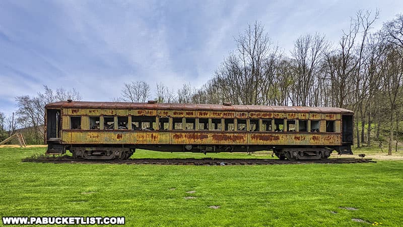 Old train car sitting below the Coral Caverns Visitor Center.