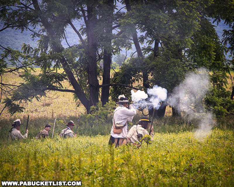 Revolutionary War-era Ranger reenactors demonstrating combat techniques at Fort Roberdeau in Blair County Pennsylvania.