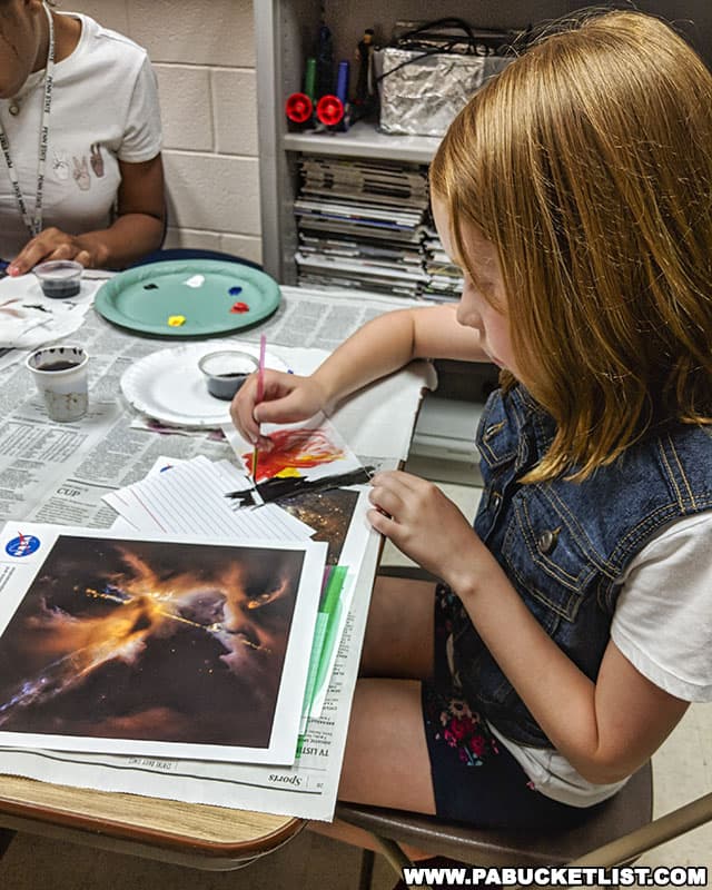 Painting galaxies and nebulas at Astrofest during Arts Fest in State College.