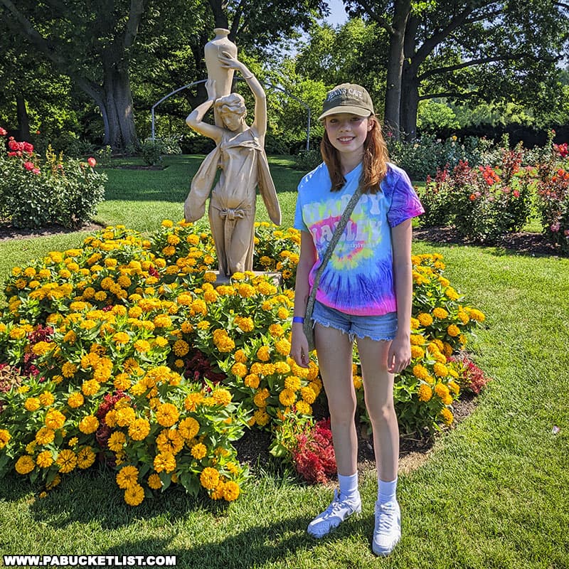 A garden statue surrounded by colorful blooms. at Hershey Gardens