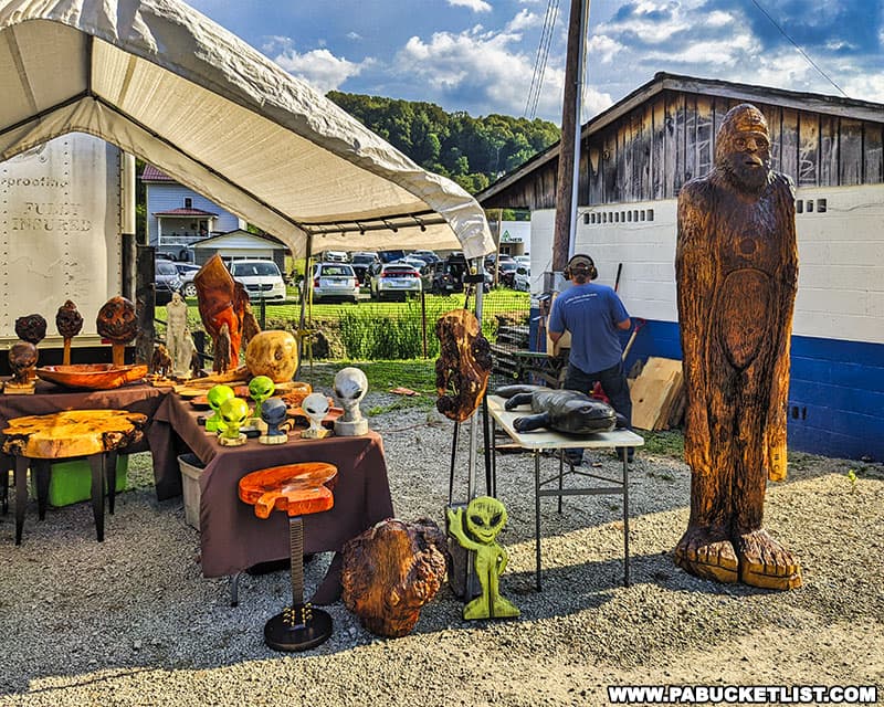 Chainsaw carvings featuring aliens and Bigfoot at the Kecksburg UFO Festival.