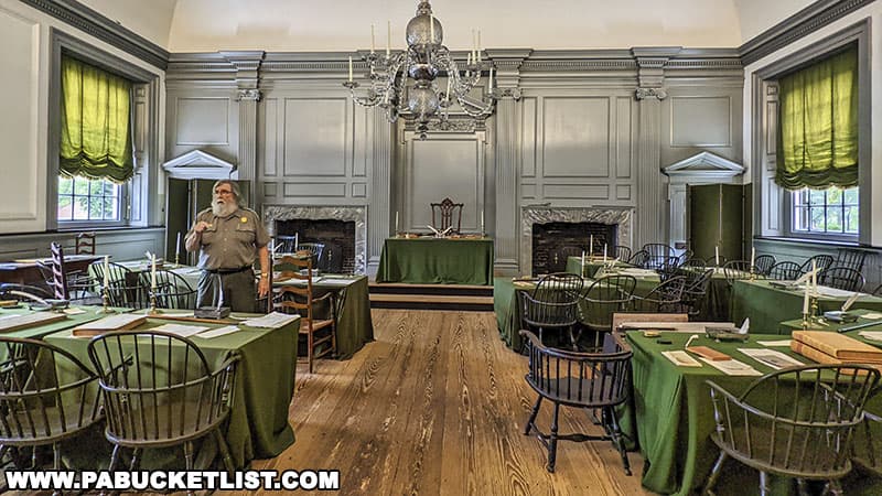 A Park Ranger explains the historic significance of the Assembly Room at Independence Hall.