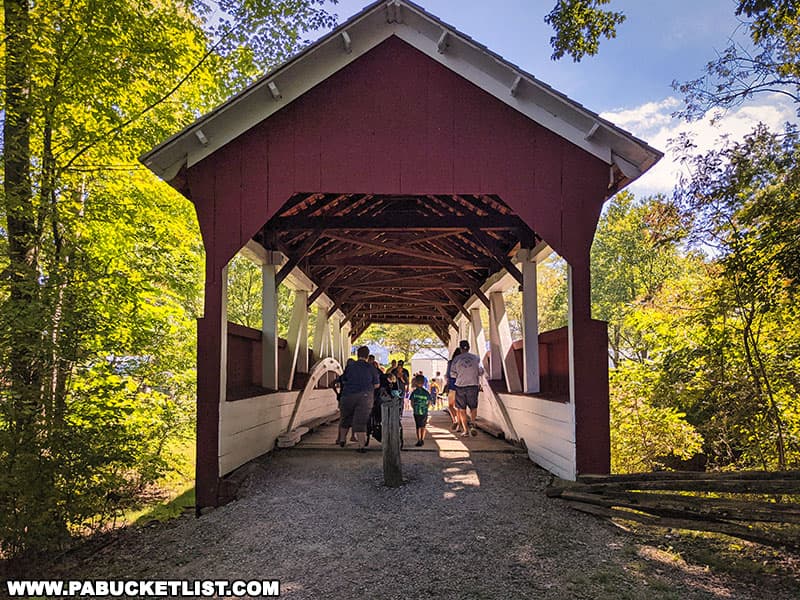 People passing through Walters Mill Covered Bridge at Mountain Craft Days in Somerset Pennsylvania.