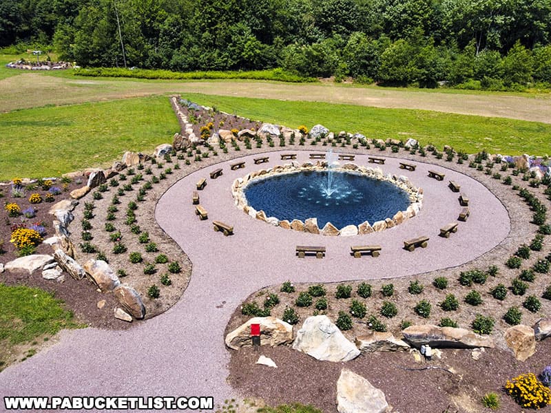 20 concrete benches resembling wooden timbers surround the fountain and create a place for rest and reflection at the Remember Me Rose Garden near Shanksville Pennsylvania.