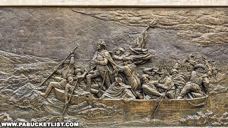 A bronze sculpture outside the Museum of the American Revolution depicting the famous painting Washington Crossing the Delaware.