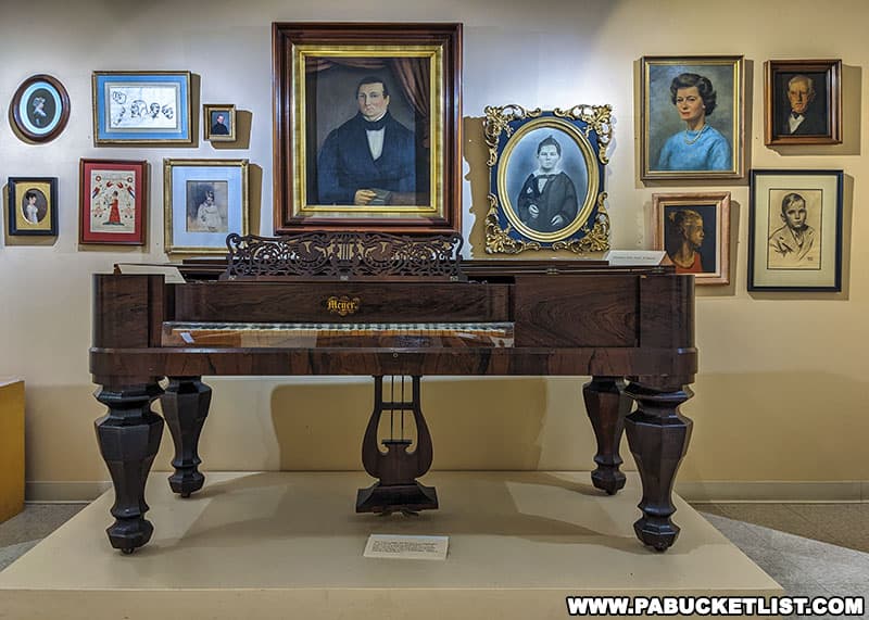 An antique piano on display in the Fine & Decorative Arts Gallery at the Taber Museum in Williamsport Pennsylvania.