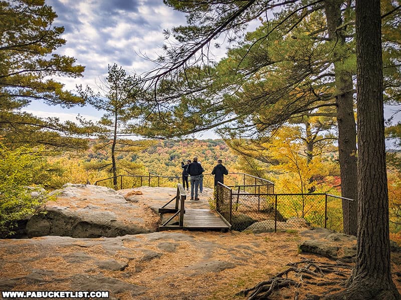 Hikers taking in the fall foliage views from Seneca Point in Clarion County.