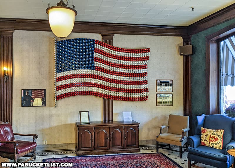 This flag in the Penn Wells Hotel lobby was designed and constructed by employees of the Wellsboro Division of the Corning Glass Works corporation in 1946 to honor its returning World War II veterans.