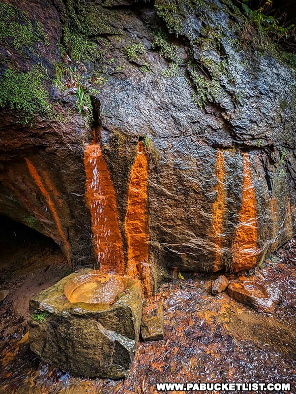 The iron-rich waters of the Frankfort Mineral Springs have stained the rocks a reddish-brown color over thousands of years.