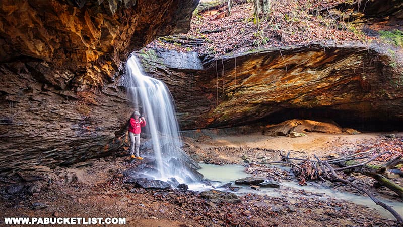 The author standing behind Frankfort Mineral Springs Falls at Raccoon Creek State Park.