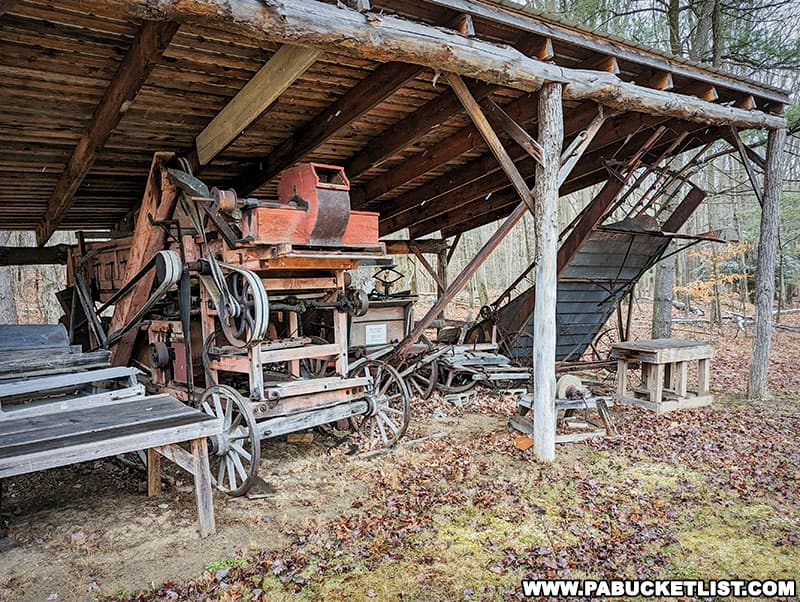 Antique farm equipment on display behind the Bloody Knox Cabin in Clearfield County Pennsylvania.