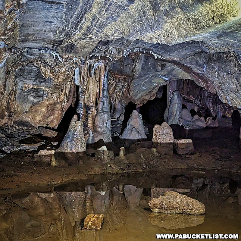 A pool of water inside Black-Coffey Caverns cast beautiful reflections when illuminated with a flashlight.