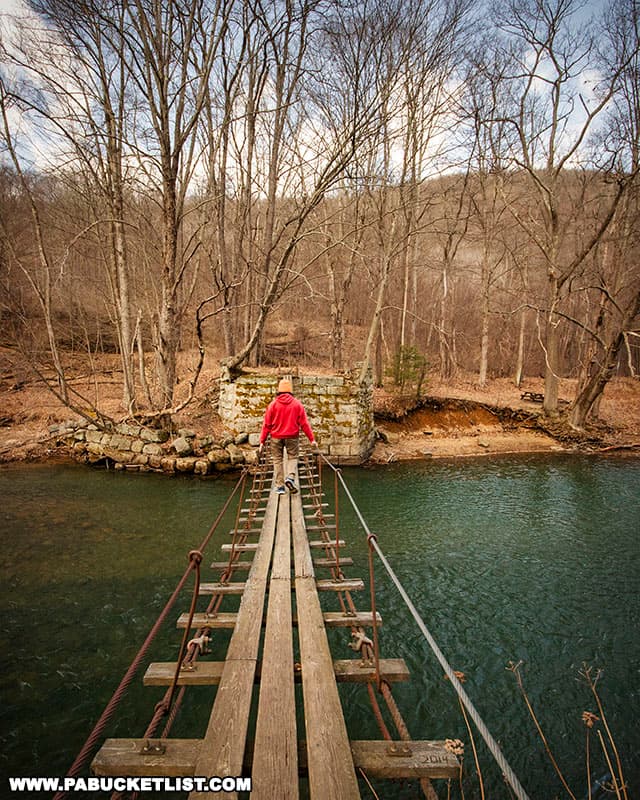 The author crossing the Blue Rock Swinging Bridge over Little Toby Creek in Elk County PA.