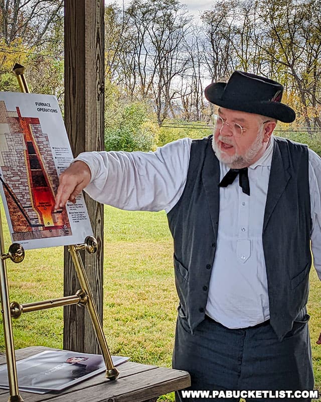 A docent portraying Roland Curtin explaining how the blast furnace works at Curtin Village.