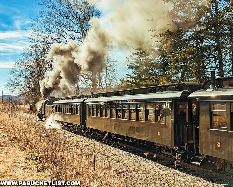 Steam locomotive pulling a passenger train along the East Broad Top Railroad in February 2023.