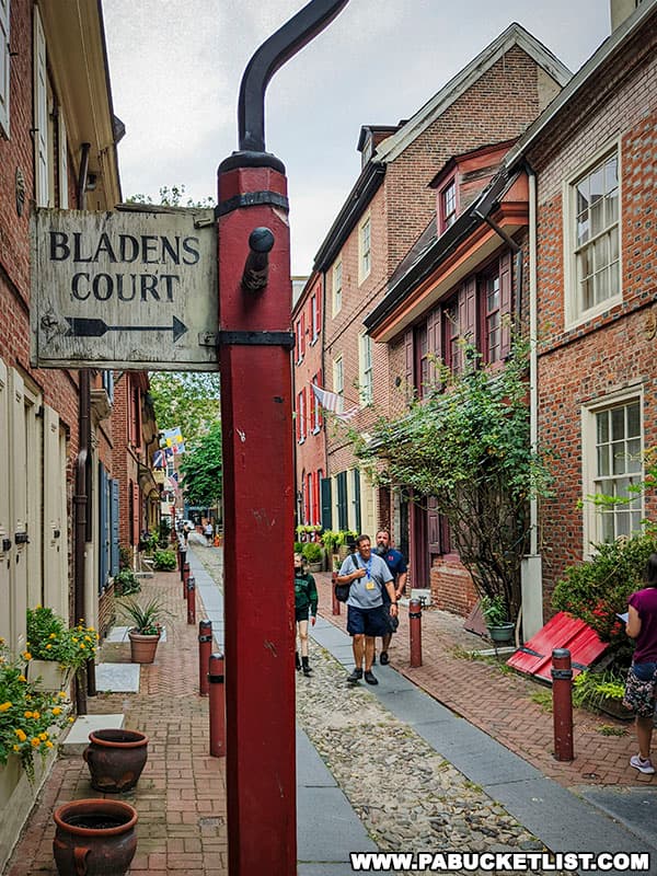 Sign pointing to Bladens Court along Elfreth's Alley in Philadelphia Pennsylvania.