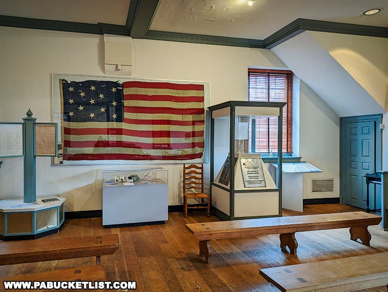 This flag hanging in the Colonial Court House is a replica of George Washington’s headquarters flag, which flew over his encampment at Valley Forge.