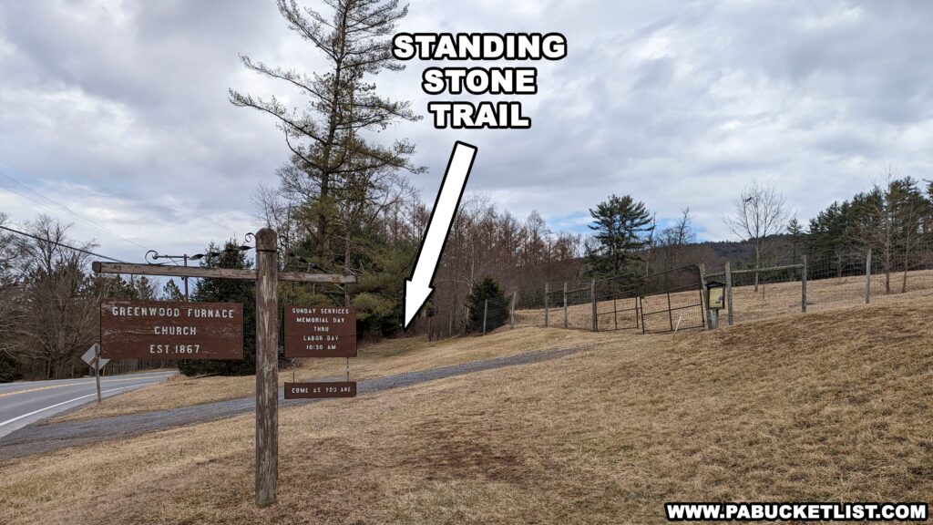 The Standing Stone Trail passes in front of the Greenwood Furnace Church and follows the edge of some tall deer fence up around a tree nursery field.