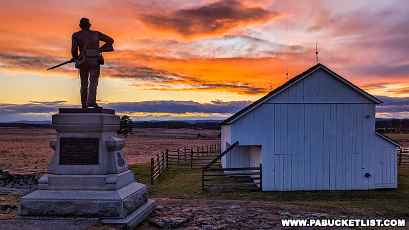 Sunset over the Gettysburg battlefield with the 11th New York Infantry monument in the foreground.