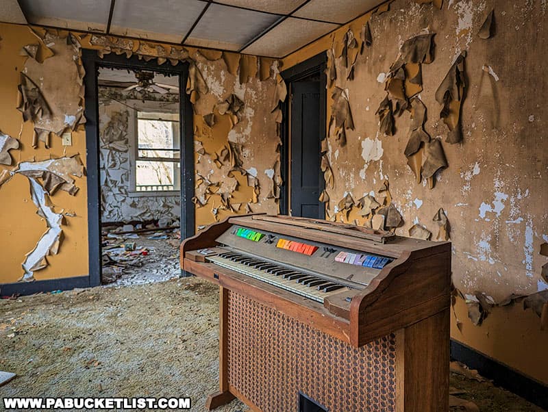 An abandoned organ inside one of the homes at Yellow Dog Village.