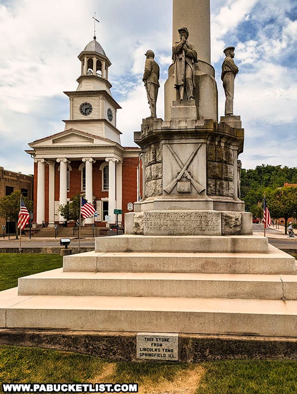 Close-up of the Soldiers and Sailors Monument in Lewistown with the historic Mifflin County Courthouse in the background.